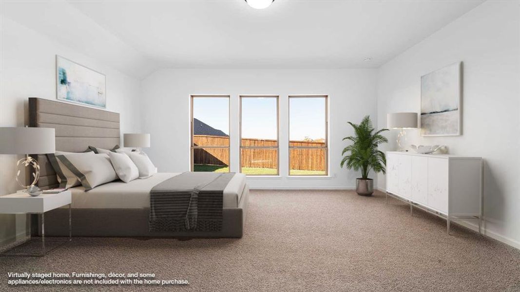 Bedroom featuring carpet floors and vaulted ceiling