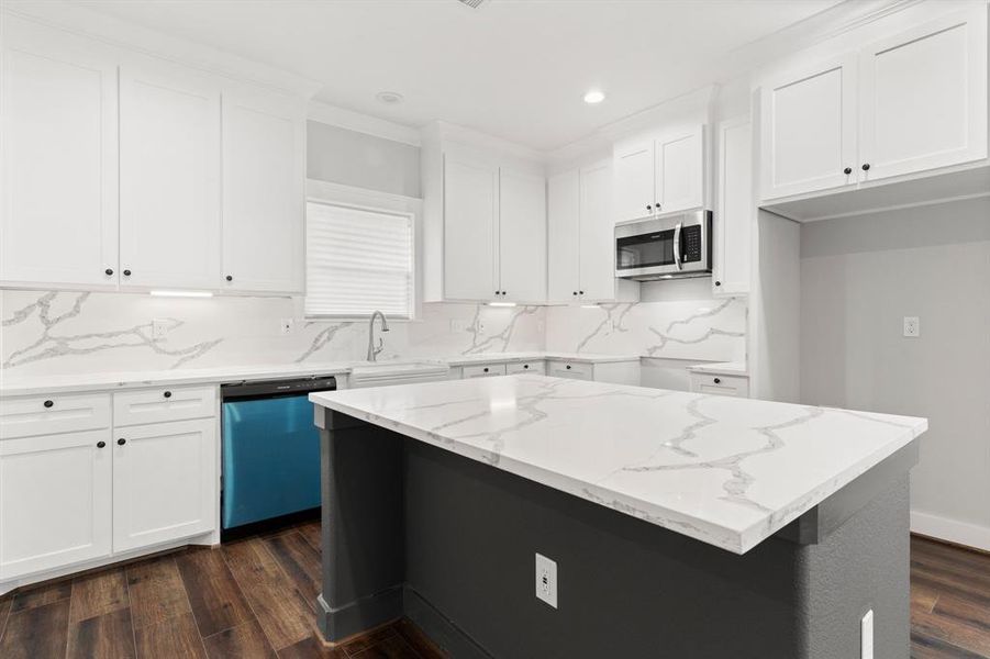 This is a modern kitchen with white cabinetry, Farmhouse sink. It features a bright, clean design.