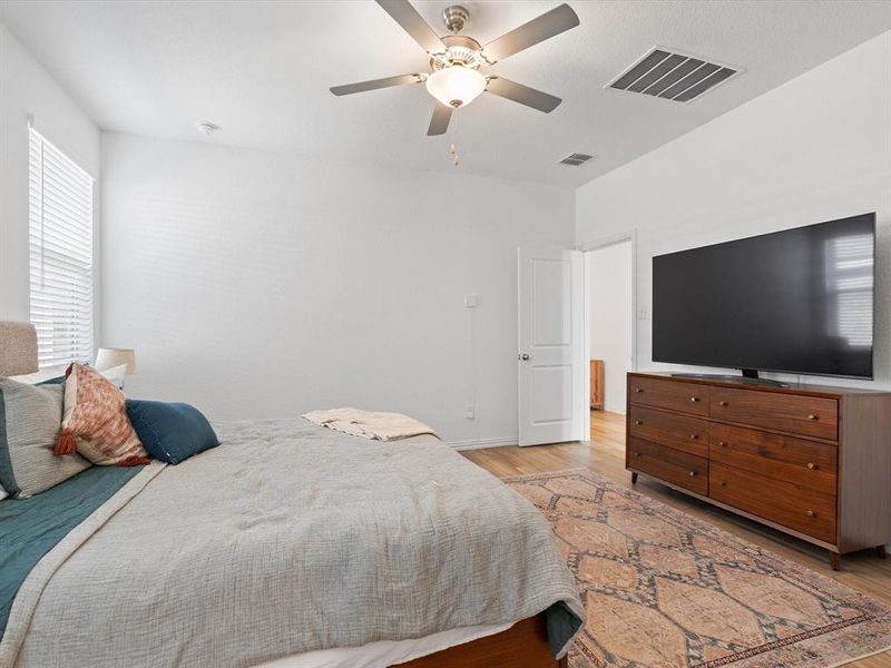 Bedroom with ceiling fan and light hardwood / wood-style flooring