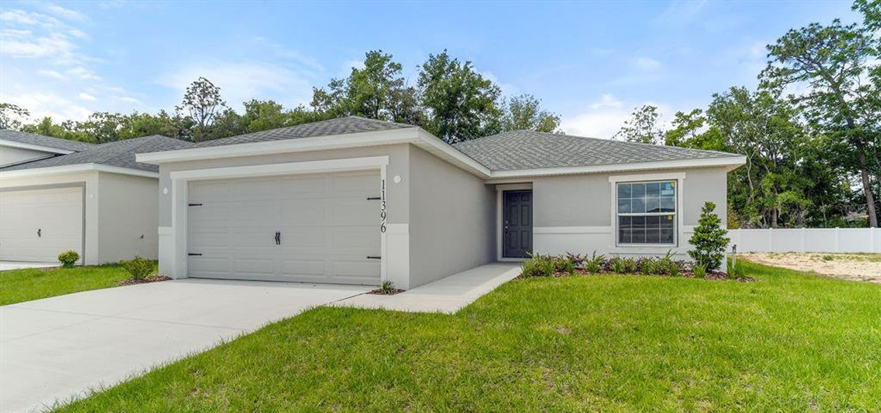 Front exterior of a new home in Vista Trace, Belleview, FL, highlighting curb appeal (Image 1). Front exterior of a new home in Vista Trace, Belleview, FL, highlighting curb appeal (Image 1).