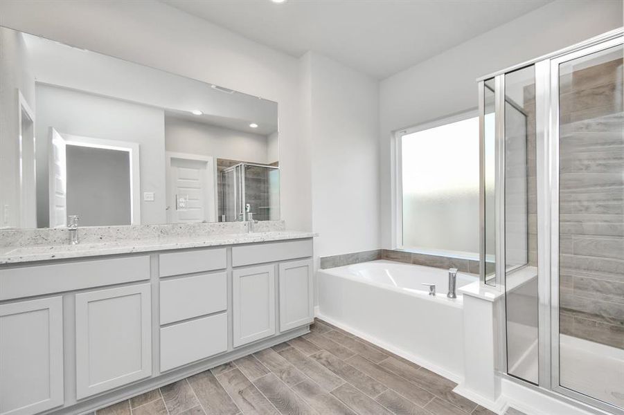 Experience a spa-like escape right in the heart of your primary bathroom. Sample photo of completed home with similar floor plan. As-built interior colors and selections may vary.