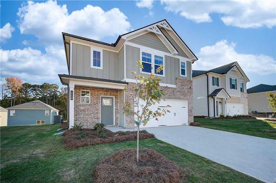 Front exterior of a new home in Abbotts Crossing, Conyers, GA, highlighting curb appeal (Image 24). Front exterior of a new home in Abbotts Crossing, Conyers, GA, highlighting curb appeal (Image 24).