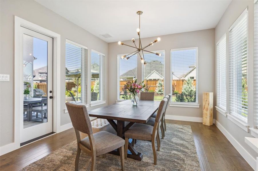 Dining area with an inviting chandelier and  hardwood / wood-style floors