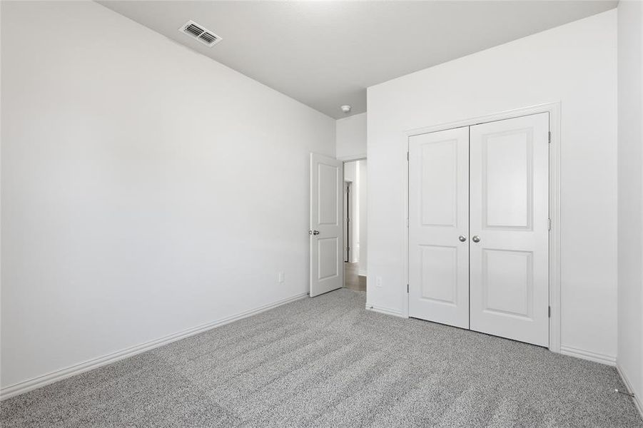 Unfurnished bedroom featuring carpet flooring and a closet
