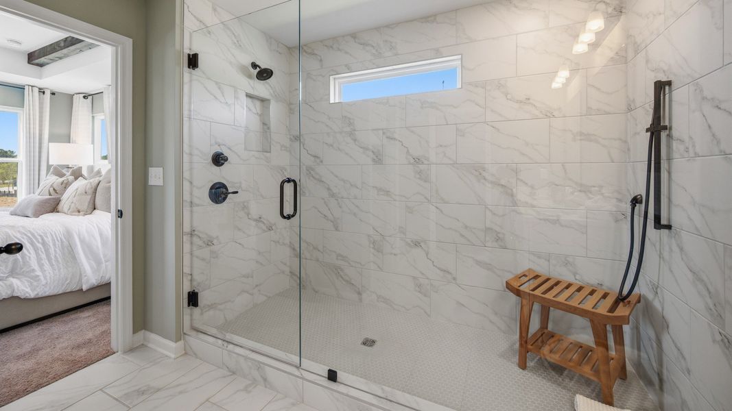 Bathroom with spacious glass enclosed shower with a shower window Bathroom with spacious glass enclosed shower with a shower window