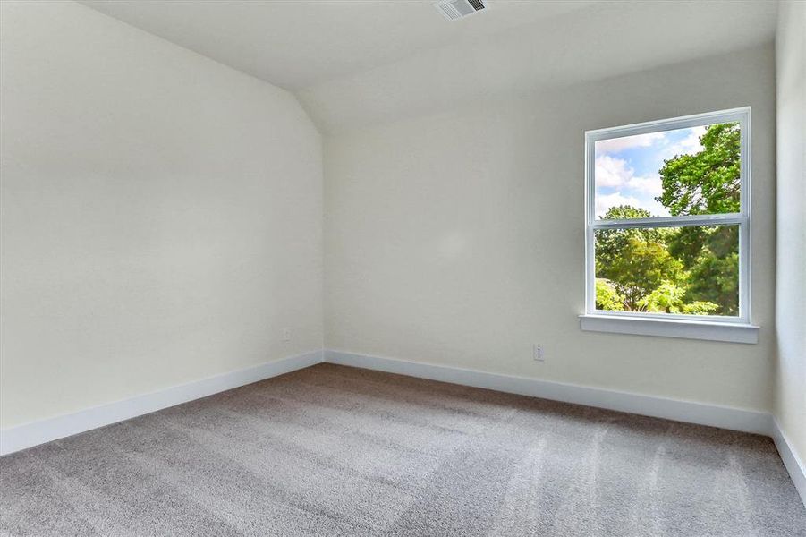 Neutral wall paint with white trim, a double-hung window, and gray carpeted flooring Neutral wall paint with white trim, a double-hung window, and gray carpeted flooring