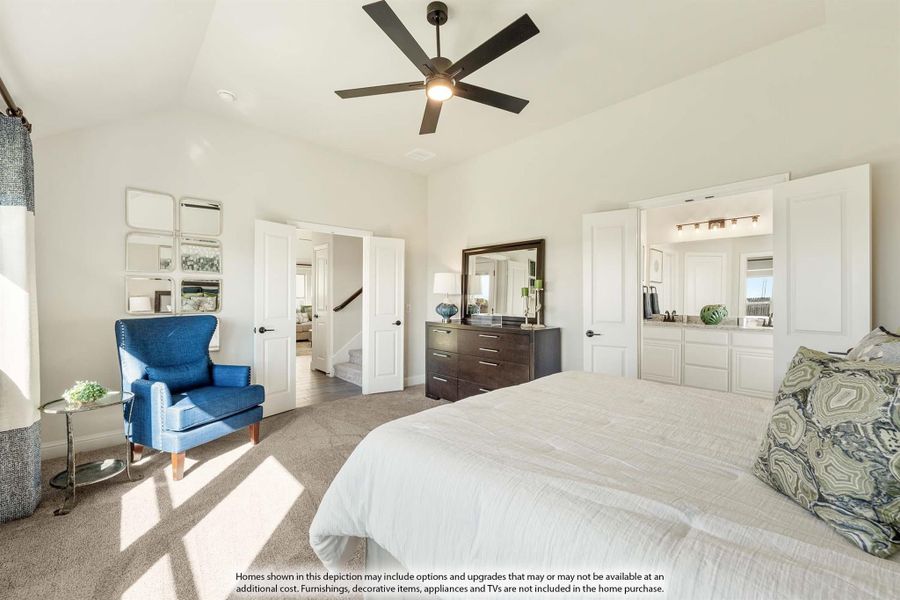 Spacious master bedroom with ceiling fan, carpet flooring, and ensuite bathroom access