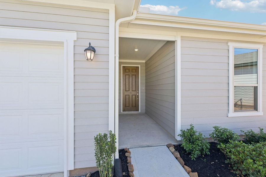 Welcome guests with this elegant and protected front entry, designed for both style and functionality. The deep-set porch provides a sheltered transition from the outdoors while adding architectural depth to the home’s contemporary facade.