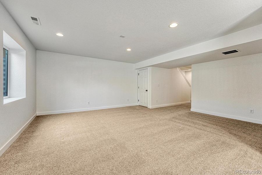 Generously sized rec room is pre-plumbed for a wet bar.