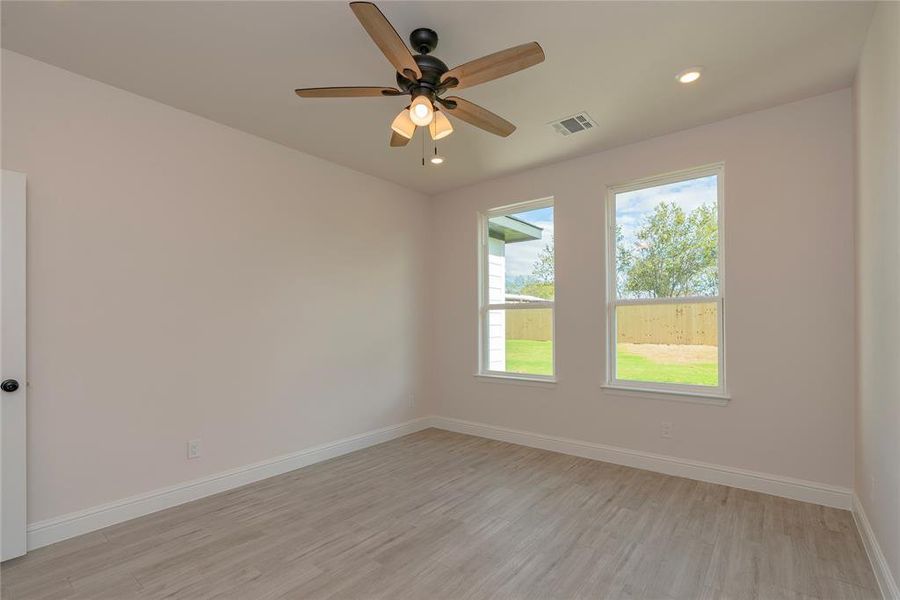 Unfurnished room featuring light hardwood / wood-style floors and ceiling fan