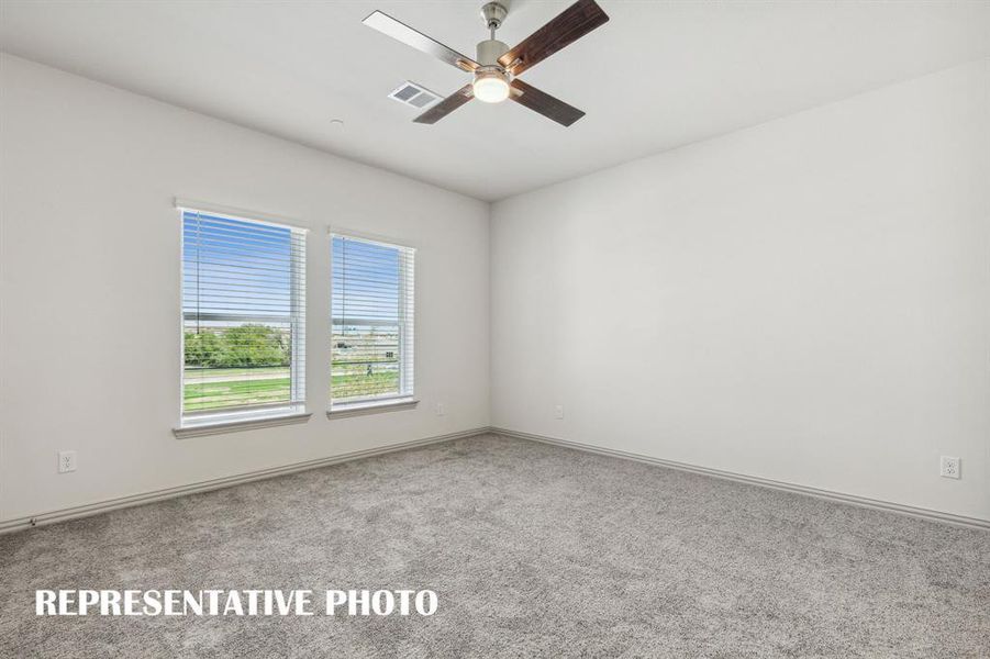 This peaceful light filled owner's bedroom is the perfect place to relax after a long day.  REPRESENTATIVE PHOTO