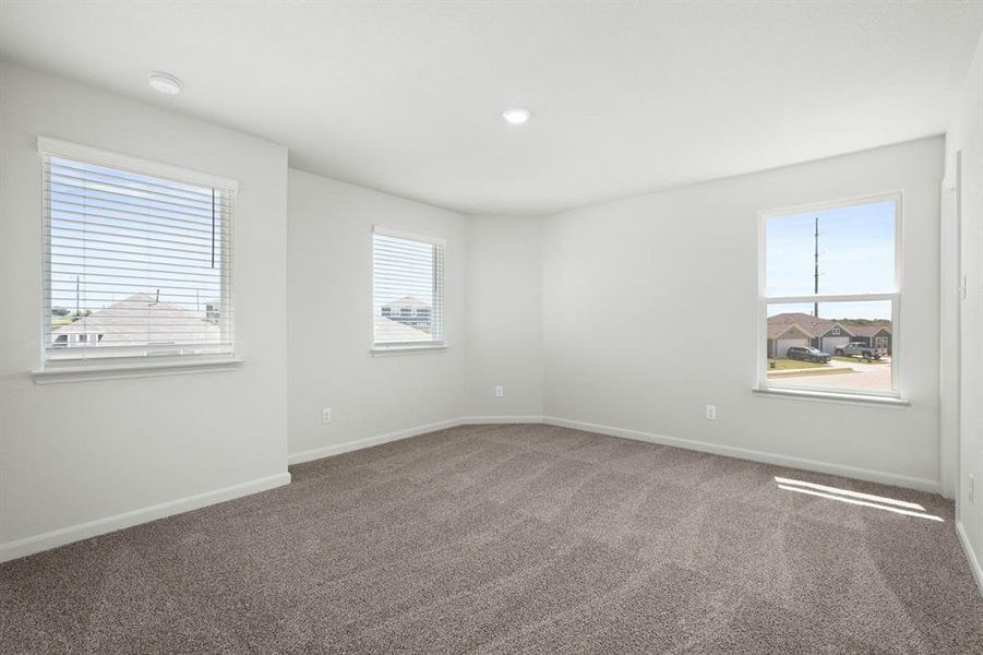Empty room with carpet, plenty of natural light, and recessed lighting Empty room with carpet, plenty of natural light, and recessed lighting
