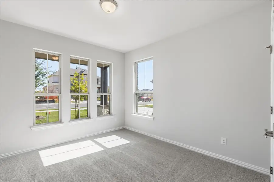 Carpeted empty room with baseboards Carpeted empty room with baseboards