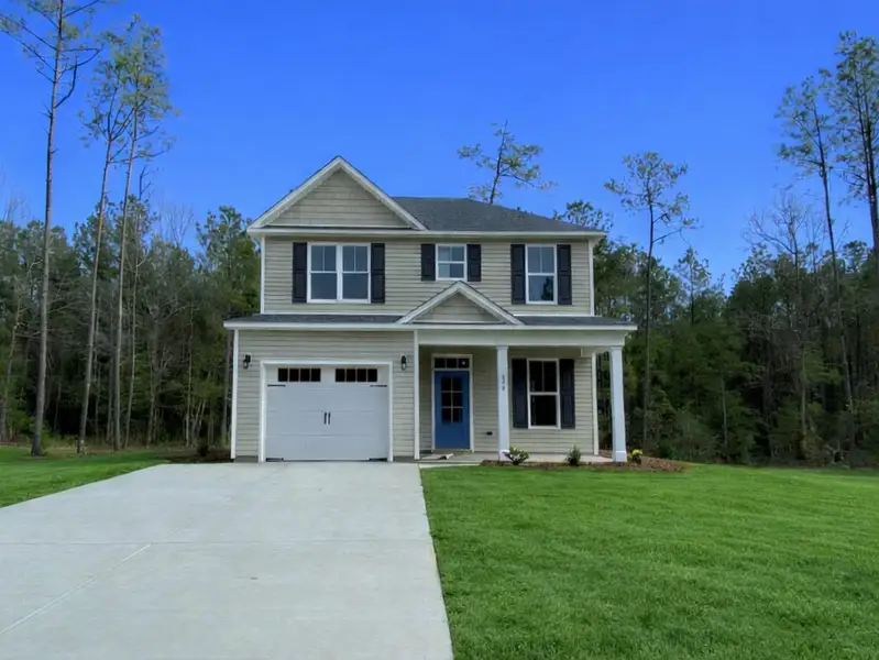 Front exterior of a new home in Patriot’s Watch, Hampstead, NC, highlighting curb appeal (Image 1). Front exterior of a new home in Patriot’s Watch, Hampstead, NC, highlighting curb appeal (Image 1).
