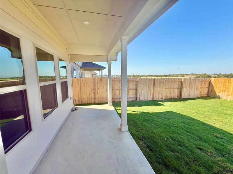 Fenced backyard with a patio area Fenced backyard with a patio area