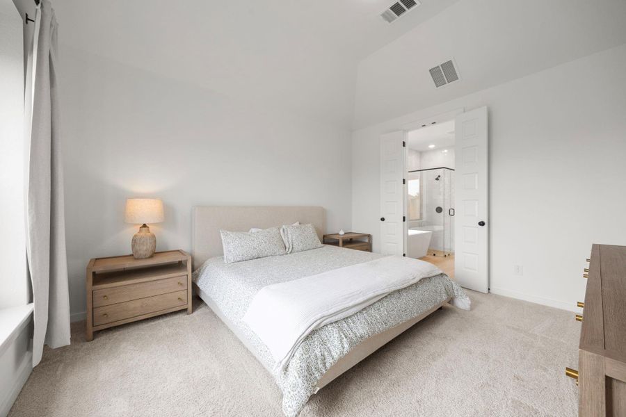 Your primary bedroom has continued high ceilings.