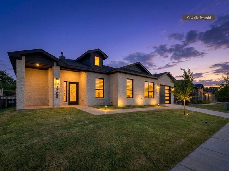 Contemporary stucco-finish exterior with dark trim and a dark roofline