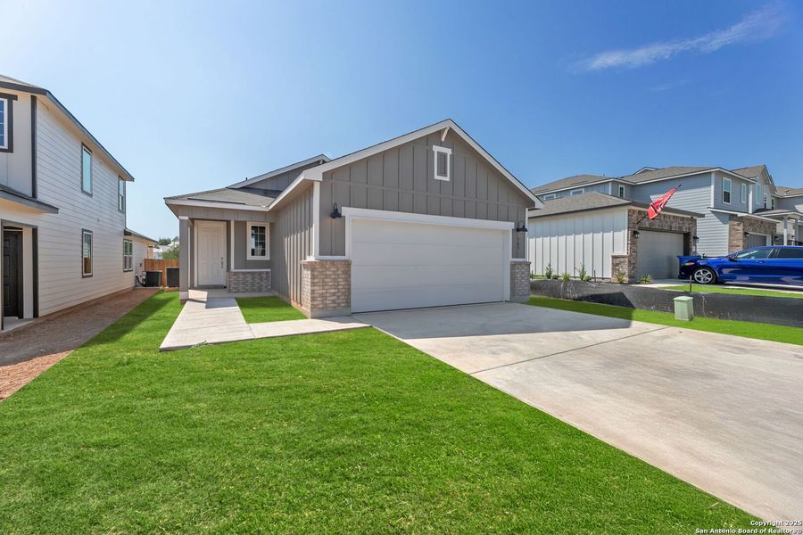 Front exterior of a new home in Highland Ridge, New Braunfels, TX, highlighting curb appeal (Image 2).