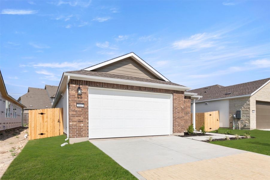 Front exterior of a new home in The Enclave at Hidden Oaks, Georgetown, TX, highlighting curb appeal (Image 18). Front exterior of a new home in The Enclave at Hidden Oaks, Georgetown, TX, highlighting curb appeal (Image 18).
