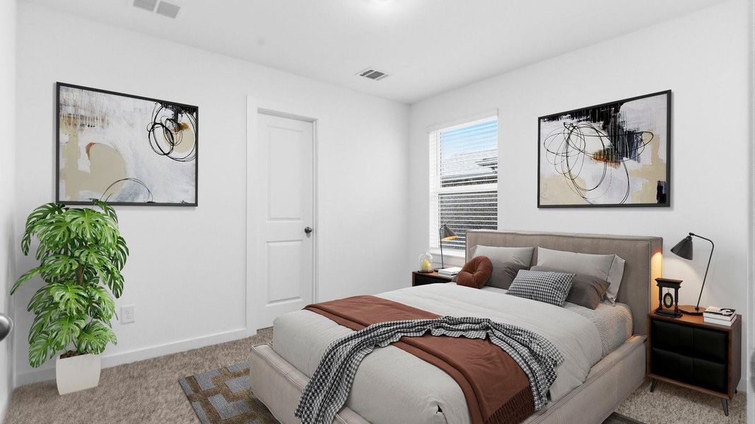 Comfortable guest bedroom featuring neutral-toned walls, carpeted flooring, and a separate closet. Comfortable guest bedroom featuring neutral-toned walls, carpeted flooring, and a separate closet.