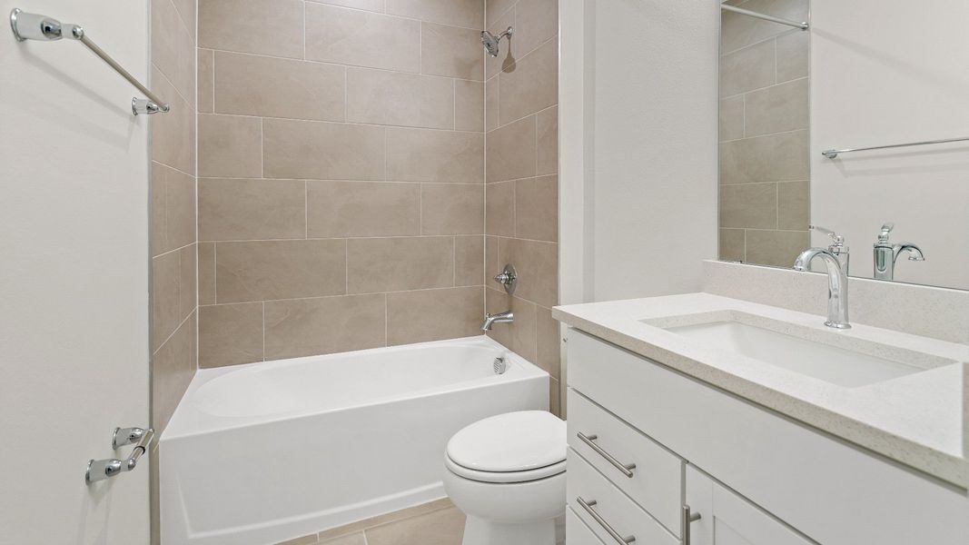 The Atlantic’s guest bath features a tiled tub-shower combo, sleek white vanity, and contemporary finishes in Lakeland, FL. The Atlantic’s guest bath features a tiled tub-shower combo, sleek white vanity, and contemporary finishes in Lakeland, FL.