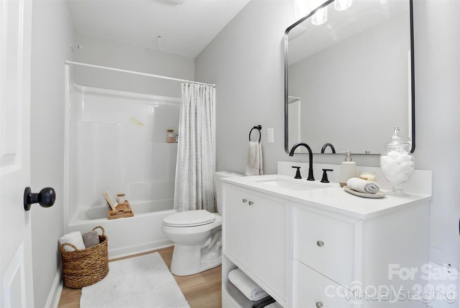 Second full bath on second floor, to be shared between other two bedrooms (virtually staged/enhanced).