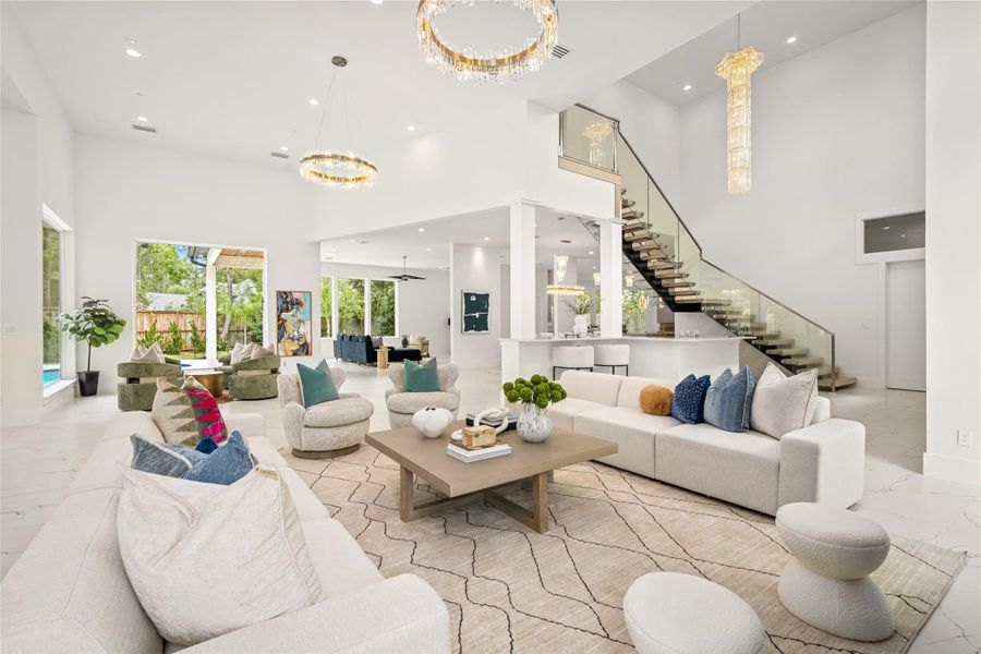 An architectural showpiece, the custom glass balustrade staircase is complemented by a sleek 14’ x 9’ bar thoughtfully tucked beneath—maximizing space and offering the perfect spot for socializing. An architectural showpiece, the custom glass balustrade staircase is complemented by a sleek 14’ x 9’ bar thoughtfully tucked beneath—maximizing space and offering the perfect spot for socializing.