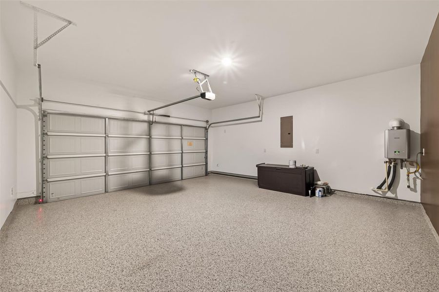Finished garage featuring an upgraded epoxy-coated floor, adding both durability and a polished look to the space.
