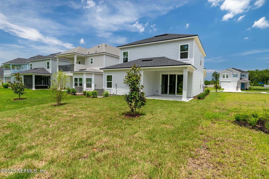 Front exterior of a new home in Beacon Lake, St. Augustine, FL, highlighting curb appeal (Image 26).