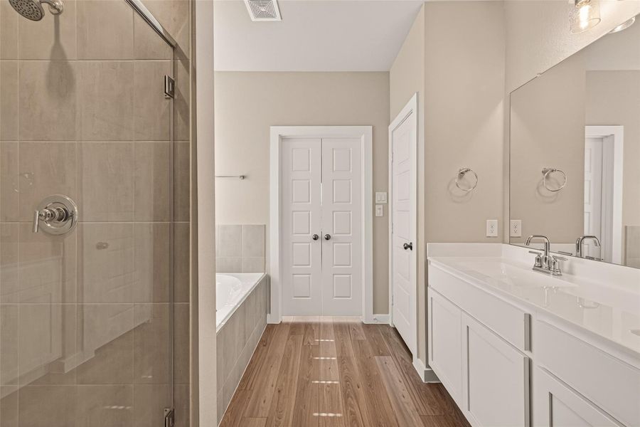 The private primary bath features dual sinks, a relaxing soaking tub, and a separate shower for added comfort and convenience. The private primary bath features dual sinks, a relaxing soaking tub, and a separate shower for added comfort and convenience.