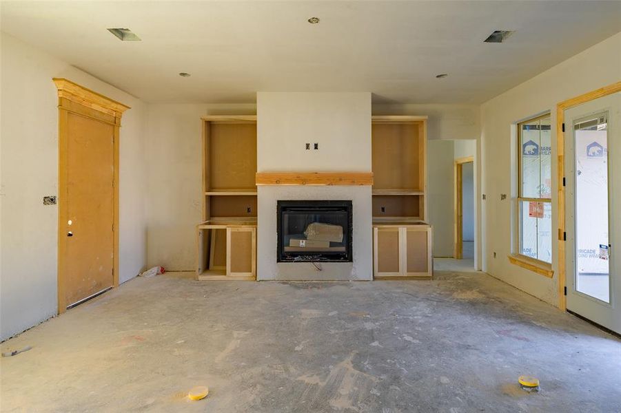 Unfurnished living room with concrete flooring