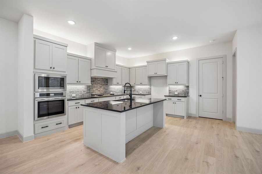 The spacious island is the hub of your new chef's kitchen and the perfect place for friends and family to gather round.