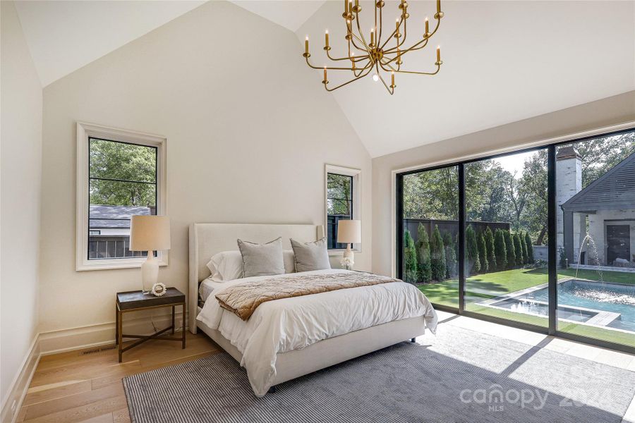 Primary bedroom with soaring vaulted ceiling