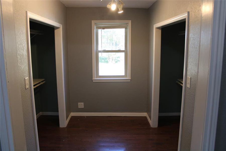 Unfurnished bedroom with dark wood-type flooring and a closet Unfurnished bedroom with dark wood-type flooring and a closet
