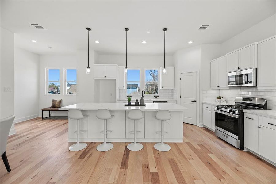 There’s a large, walk-in pantry, stainless appliances and great lighting in this very functional kitchen.