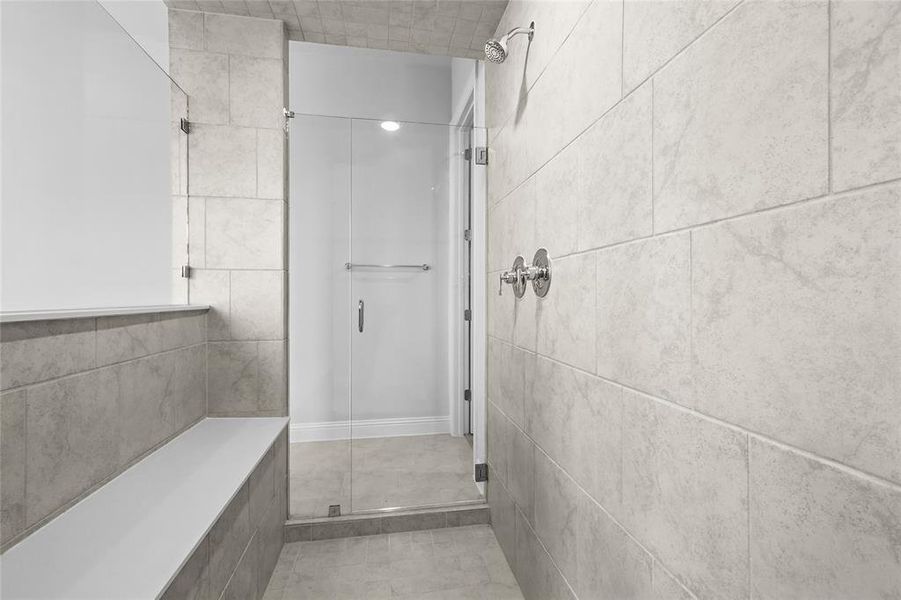 Bathroom with a stall shower and tile patterned floors Bathroom with a stall shower and tile patterned floors