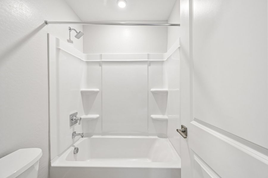 A bathroom with a tub and sink.
