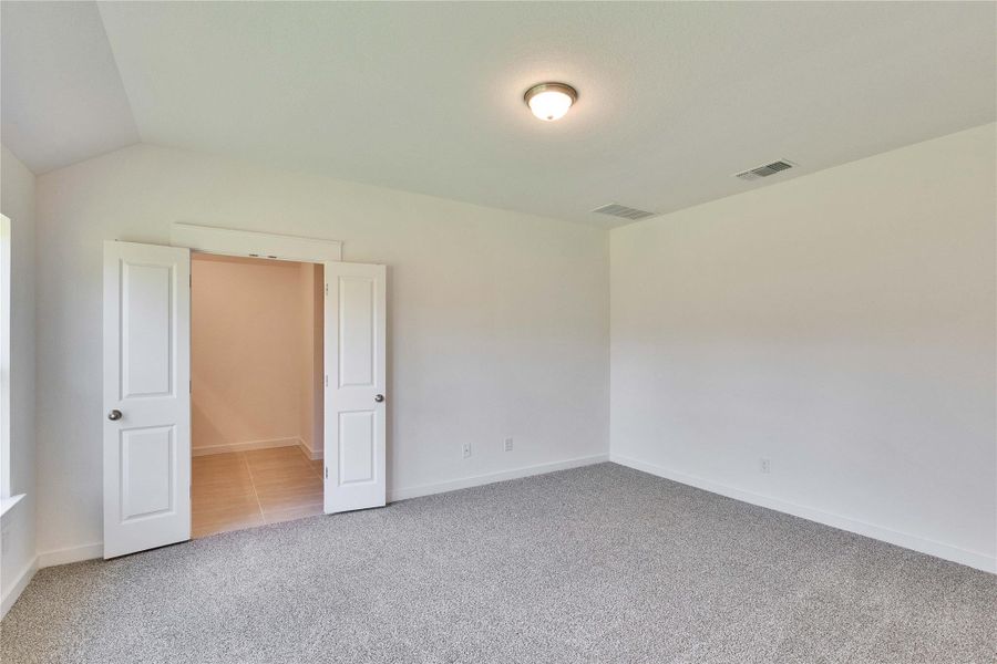 Spare room with light colored carpet and baseboards Spare room with light colored carpet and baseboards