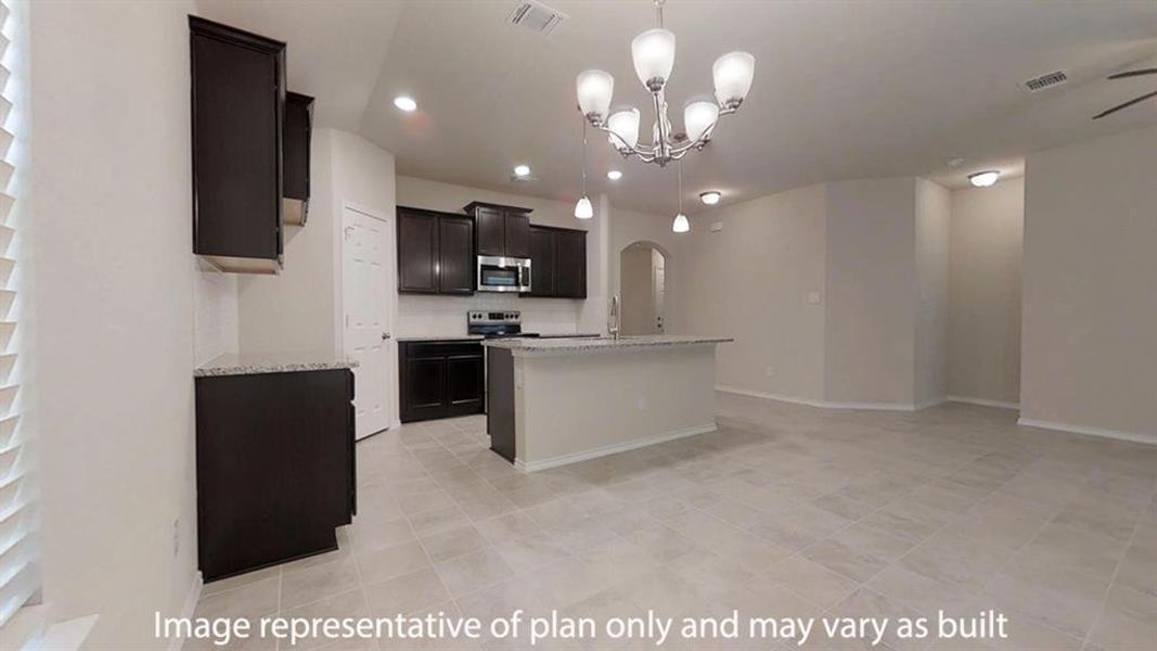 Kitchen featuring pendant lighting, light stone counters, a center island with sink, a chandelier, and stainless steel appliances Kitchen featuring pendant lighting, light stone counters, a center island with sink, a chandelier, and stainless steel appliances