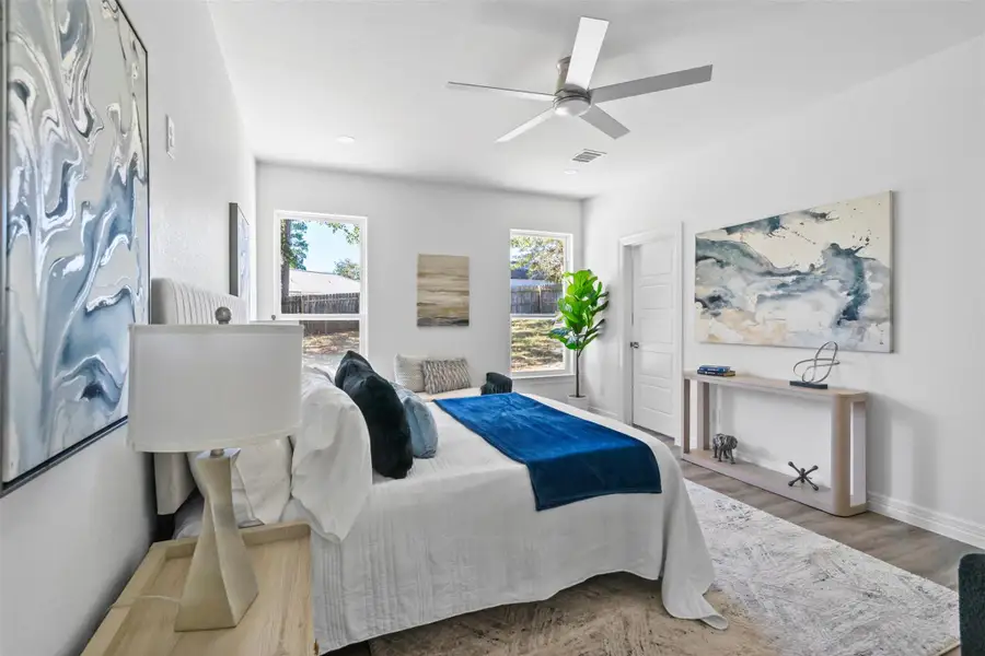 Bedroom with wood finished floors, a ceiling fan, and recessed lighting