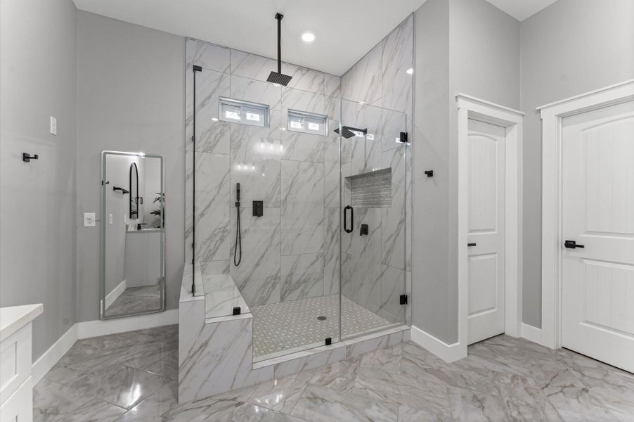 Primary bath designed for luxury—featuring a large walk-in shower with tile surround and glass enclosure. Primary bath designed for luxury—featuring a large walk-in shower with tile surround and glass enclosure.