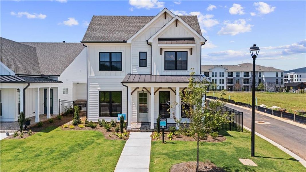 Front exterior of a new home in Promenade at Sawnee Village, Cumming, GA, highlighting curb appeal (Image 22). Front exterior of a new home in Promenade at Sawnee Village, Cumming, GA, highlighting curb appeal (Image 22).