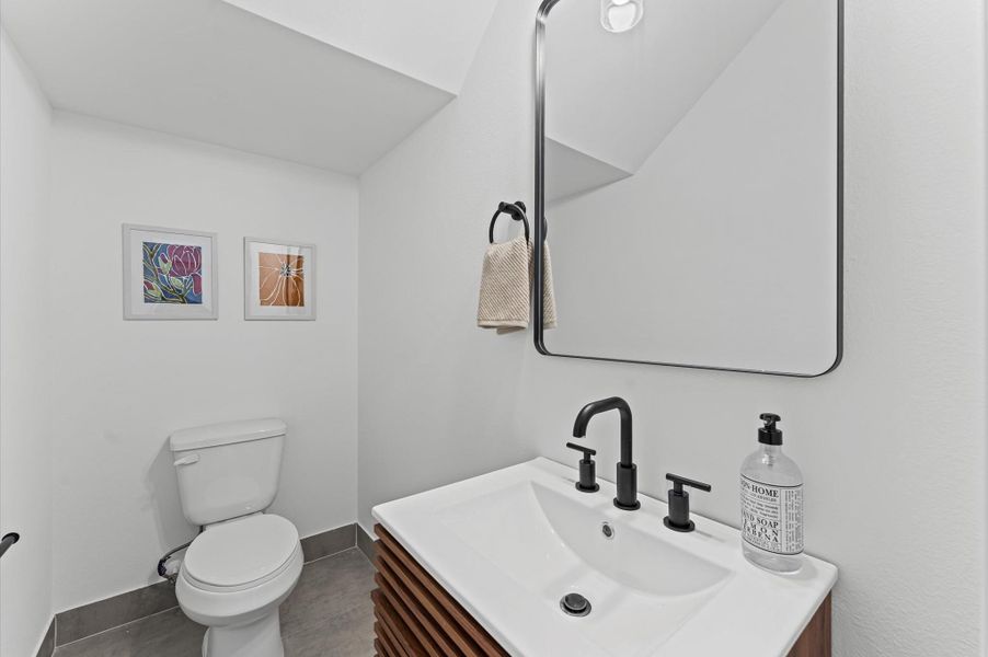 Tucked conveniently near the living area, this powder room blends accessibility with sleek contemporary style. Clean lines and modern fixtures define the space, from the minimalist vanity to the streamlined sink and faucet. Tucked conveniently near the living area, this powder room blends accessibility with sleek contemporary style. Clean lines and modern fixtures define the space, from the minimalist vanity to the streamlined sink and faucet.