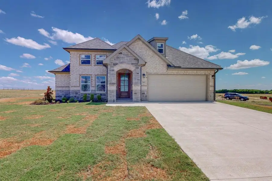 View of front of home featuring a garage and a front yard