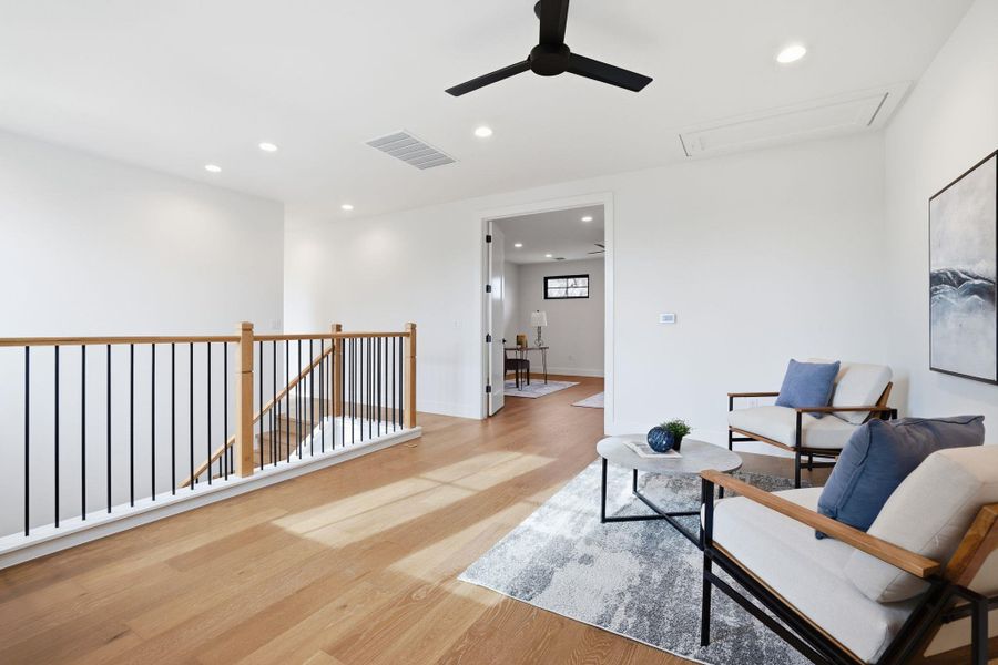Sitting room featuring an upstairs landing, recessed lighting, light wood-style floors, and a ceiling fan