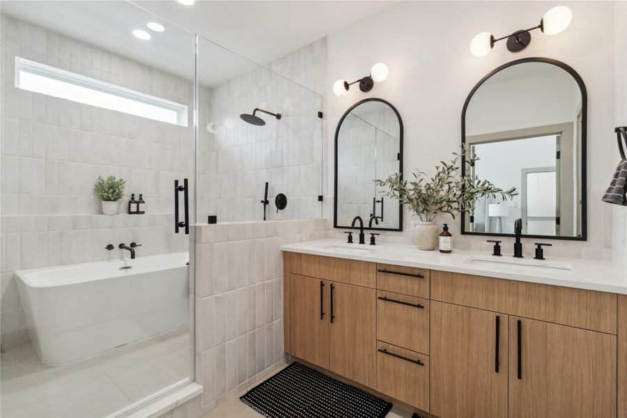 The frameless glass shower and soaking tub nook maximize light and spatial flow while delivering everyday luxury.