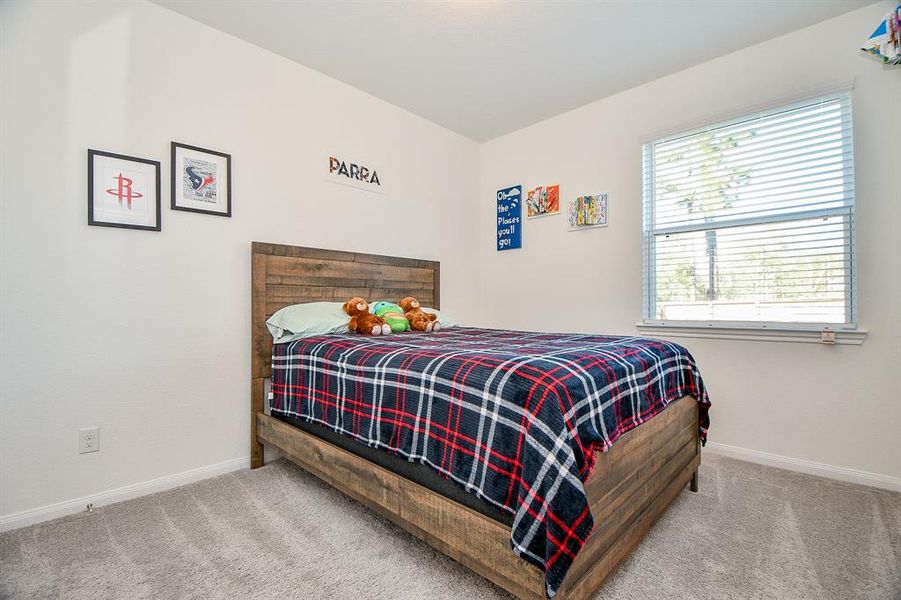 Your family and guests will rest comfortably in this roomy bedroom with soft neutral finishes, a large walk-in closet and easy access to a full bathroom.