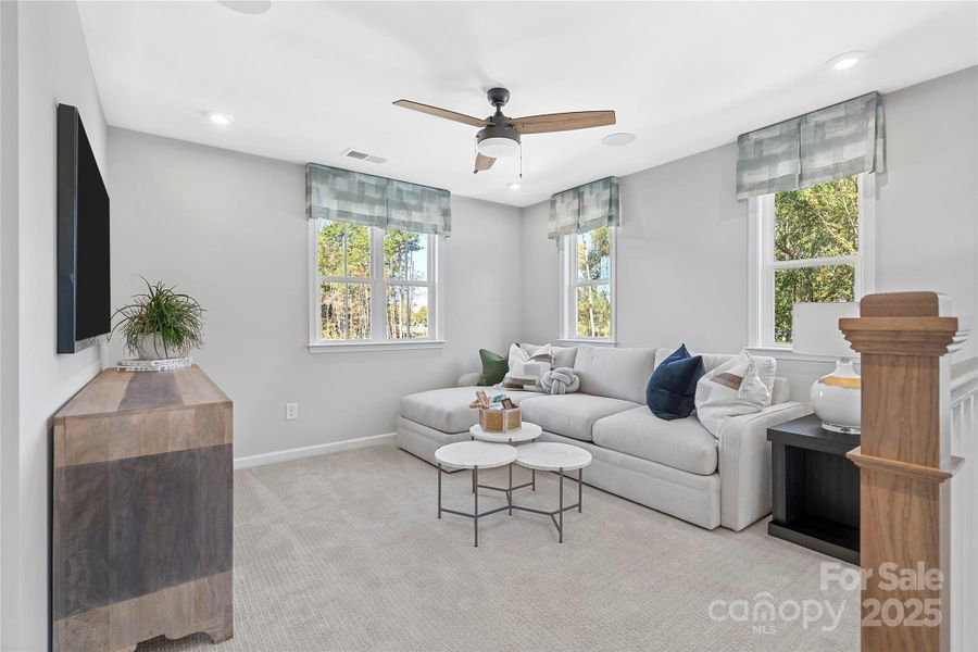 The loft creates a secondary living space with large bright windows.