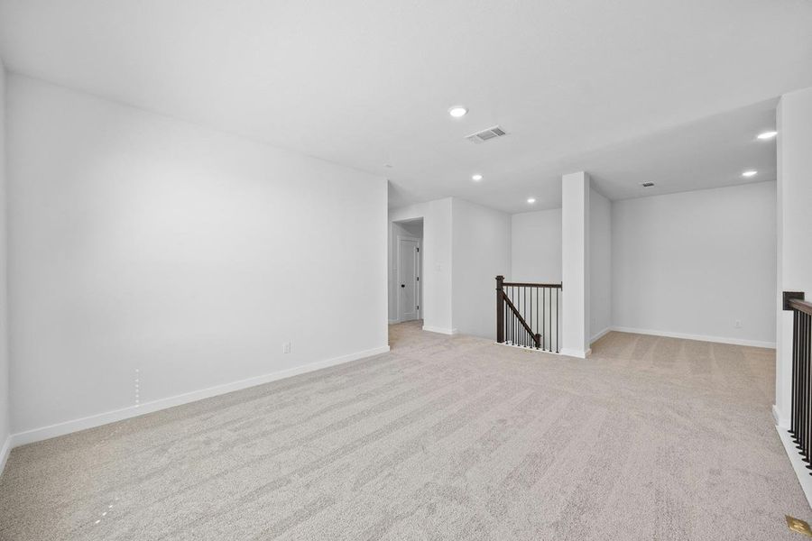Empty room featuring recessed lighting and light carpet Empty room featuring recessed lighting and light carpet