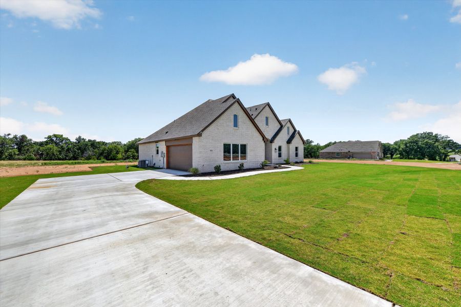 Front exterior of a new home in Taylor Ranch, Springtown, TX, highlighting curb appeal (Image 2).